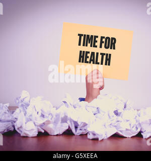 HAND MIT GELBEM PAPIER MIT ZEIT FÜR HEALTHCONCEPT Stockfoto