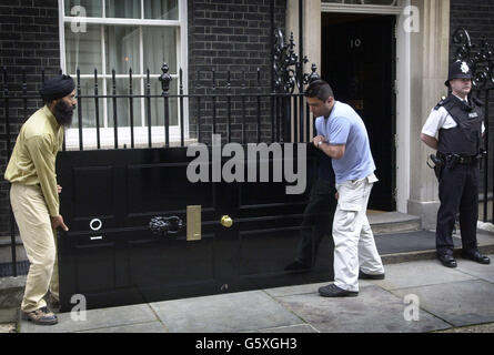 Die berühmte Eingangstür der Downing Street Nr. 10, der offiziellen Londoner Residenz des britischen Premierministers, wird für einen neuen Anstrich entfernt. Die Tür wird ein Jahr lang durch eine exakte Nachbildung ersetzt, wobei der Vorgang wiederholt wird. Stockfoto