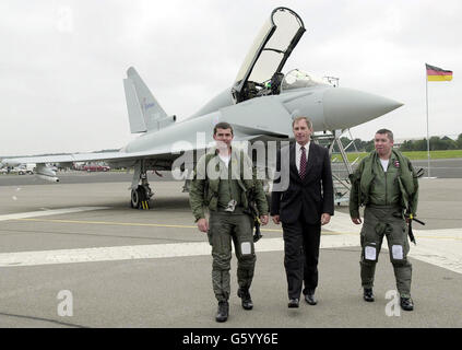 Verteidigungsminister Geoff Hoon trifft die Luftbesatzung des neuen RAF Typhoon, Craig Penrice (links) und Wing Commander David 'Charlie' Chan, nachdem das Flugzeug an einem Formationsflypast teilgenommen hatte. *....vier Eurofighter der RAF flogen über die Farnborough Airshow in einer Ausstellung, bevor das Flugzeug von Herrn Hoon den offiziellen Namen Typhoon erhielt. Der erste Typhoon soll bis Ende dieses Jahres an die RAF ausgeliefert werden. Stockfoto