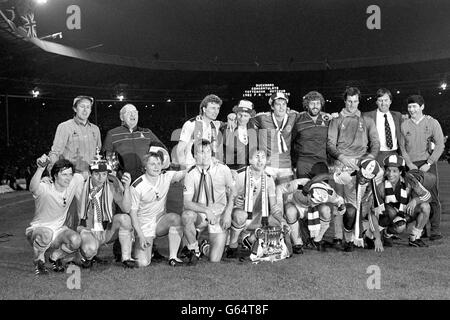 Das siegreiche Tottenham Hotspur Team in Wembley gestern Abend nach dem Sieg über Queen's Park Rangers 1-0 in der FA Cup Final Replay, mit der Trophäe vor ihnen. Stehend, von links nach rechts: Peter Shreeves (Assistant Manager), John Wallis (Kit man), Paul Price, Mike Hazard, Glenn Hoddle, Mike Varney (Physiotherapeut), Ray Clemence, Manager Keith Burkinshaw, nicht identifiziert. Vordere Reihe, von links nach rechts: Steve Perry, Tony Galvin, Garry Brooke, Paul Miller, Graham Roberts, Steve Archibald, Garth Crooks und Chris Hughton. Stockfoto