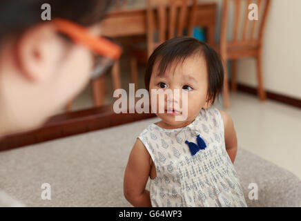 Ein zwei Jahre altes chinesisches Mädchen, große Augen schaute ihre Mutter Stockfoto