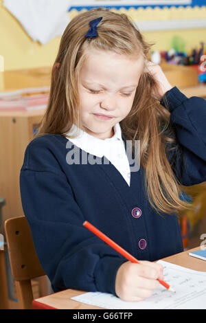 Weibliche Grundschule Schüler leiden Kopfläuse im Klassenzimmer Stockfoto
