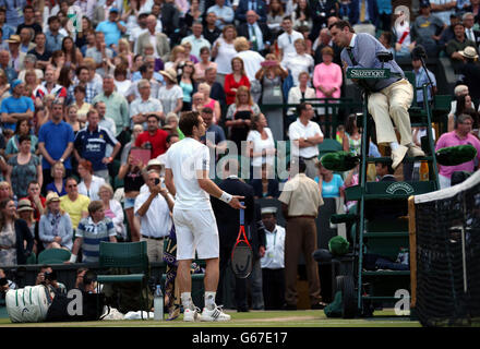 Der britische Schiedsrichter Andy Murray argumentiert mit dem Schiedsrichter Andrew Jarrett und dem Schiedsrichter über ihre Entscheidung, das Dach während seines Spiels mit dem Polens Jerzy Janowicz während des elften Tages der Wimbledon Championships beim All England Lawn Tennis and Croquet Club in Wimbledon zu schließen. Stockfoto