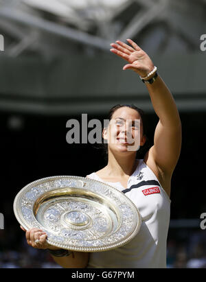 Die Französin Marion Bartoli feiert mit ihrer Trophäe, nachdem sie am 12. Tag der Wimbledon Championships im All England Lawn Tennis and Croquet Club in Wimbledon das Finale der Frauen-Singles gegen die deutsche Sabine Lisicki gewonnen hat. Stockfoto