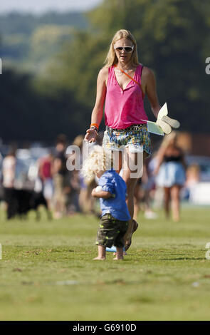 Supermodel Jodie Kidd und ihr Sohn Indio helfen, die Divots auf dem Platz während einer Pause im zweiten Halbfinale des Veuve Clicquot Polo Gold Cup im Cowdray Park in Midhurst, West Sussex zwischen Dubai und El Remanso, einzutreten. Stockfoto