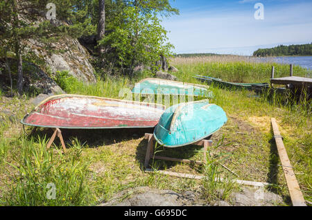 Kleine Ruderboote lag kopfüber an der Küste noch See im Schilf Stockfoto