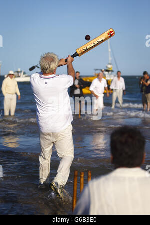 Action während des jährlichen Bramble Bank Cricket-Spiels, das auf einer Sandbank mitten im Solent bei Ebbe im Frühling stattfindet. Stockfoto