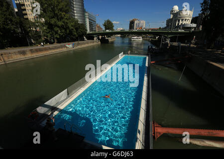 Ein Schwimmer nimmt ein Bad an Bord eines Schwimmbades auf dem Donaukanal, Wien, Österreich Stockfoto