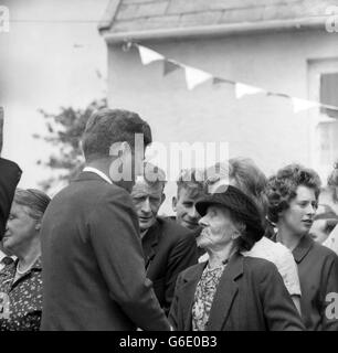 PRÄSIDENT JOHN F. KENNEDY von Amerika spricht mit FRAU MARGARET WHITTY, mit 86 Jahren seine nächste lebende Verwandte in Irland, während seines Besuchs auf der Farm, auf der seine Vorfahren in dem kleinen Weiler Dunganstown, Co. Wexford, Irland, lebten. Einige seiner Verwandten versammelten sich, um den amerikanischen Staatschef zu begrüßen. Mit Nachbarn hatten sie sich zusammengelegt, um eine Teeparty im Hof von Frau Mary Ryans Farm in der Nähe des kleinen einstöckigen Steingebäudes zu machen – alles, was von dem Haus übrig geblieben ist, in dem Präsident Kennedys Urgroßvater lebte. Stockfoto