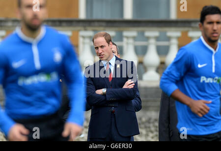 Prinz William, Duke of Cambridge in seiner Rolle als Präsident der Football Association nimmt an dem ersten Fußballspiel im Buckingham Palace zwischen dem Civil Service FC und dem Polytechnic FC Teil, das anlässlich des 150-jährigen Bestehens der FA gespielt wurde. Stockfoto