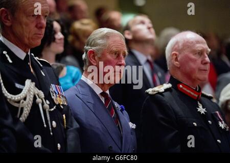 Der Prinz von Wales sitzt mit Sir Bernard Hogan-Howe Kommissar der Metropolitan Police (links) und dem Lord Lieutenant von South Glamorgan Dr. Peter Beck (rechts) während des National Police Memorial Day, einer jährlichen Gedenkveranstaltung zu Ehren aller Offiziere, die seit Beginn der modernen Polizeiarbeit im Jahr 1792 im Dienst getötet wurden, In der St. David's Hall in Cardiff in Wales. Stockfoto