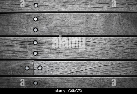Dunkel graue Wand aus Holzbrettern mit Schrauben, Foto Hintergrundtextur Stockfoto