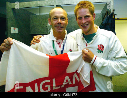 England-Coach Clive Woodward, links, wird vom britischen Prinz Harry gratuliert, als sie in der Garderobe nach ihrem Rugby-Weltcup-Sieg über Australien in Sydney feiern. England besiegte Australien 20-17 in der Extrazeit. Stockfoto