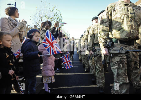 Mitglieder der öffentlichen Welle Fahnen während der Heimkehr Parade für das 4. Bataillon der Gewehre, Salisbury. Stockfoto