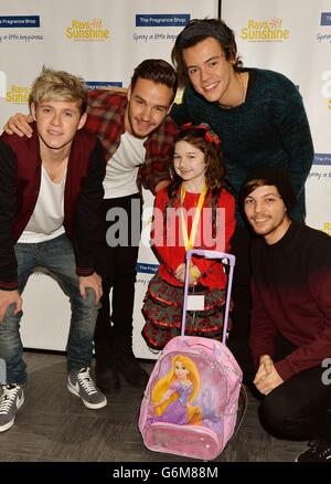 Vier Mitglieder der Boyband One Direction (von links nach rechts) Niall Horan, Liam Payne, Harry Styles und Louis Tomlinson mit Fan Amileigh O'Hagan aus Manchester, bei der Kinderhilfsorganisation Rays of Sunshine, die den Bandfilm This is US im Cineworld Wembley in London zeigt, Als kranke Kinder bekommen die Chance, ihre Helden zu treffen und Tickets für ihre Konzerte im nächsten Jahr zu gewinnen. Stockfoto