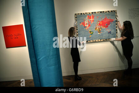 Die Mitarbeiter von Christie posieren mit „Mappa“ von Alighiero Boetti während einer Vorschau auf Christie's Eyes Wide Open: An Italian Vision Sale bei Christie's, Mayfair, London. Stockfoto