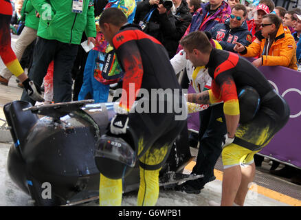 Der russische Ministerpräsident Dmitri Medwedew (zweiter links oben) beobachtet die Herren-Bobbahn im Sanki Sliding Center während der Olympischen Spiele 2014 in Sotschi in Krasnaja Poljana, Russland. Stockfoto