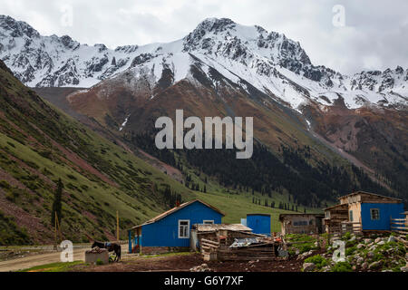 Blaue Häuser mit Schnee bedeckt Berge. Stockfoto