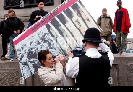 Mitglieder der "PETA", Menschen für den ethischen Umgang mit Tieren, peitschten sich auf dem Londoner Trafalger Square mit der Polizei, wo sie versuchten, ihre Ausstellung "Holocaust on your Plate" zu enthüllen, die die Art und Weise, wie Juden in Nazi-Deutschland behandelt wurden, mit der Art und Weise vergleicht, wie Tiere in unserem aktuellen Klima behandelt werden. Die Ausstellung wurde von der City of Westminster und der Greater London Authority verboten. Stockfoto