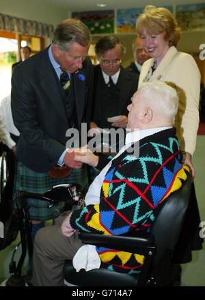 NUR FÜR DEN EINSATZ IM AUSLAND; der Prinz von Wales trifft auf den ehemaligen Black Watch-Platoon-Sergeanten Charles Swanson, 83, während eines Besuchs im Erskine Ex-Servicemans Hospital in Beith, Ayrshire. Der Veteran schalt den Prinzen, weil er den Tartan seines Regiments nicht trug, obwohl Charles, der eine Gordon Highlanders Krawatte und einen grünen Hunting Stewart Kilt trug, dem alten Soldaten erzählte, dass er gestern eine Black Watch Krawatte getragen habe. Charles ist Oberst beider Regimenter. Stockfoto