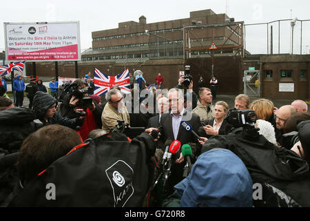 Sinn Fein's Gerry Kelly (Mitte) spricht mit den Medien vor der Antrim Polizeistation, nachdem sie Sinn Fein Präsident Gerry Adams besucht haben. Stockfoto