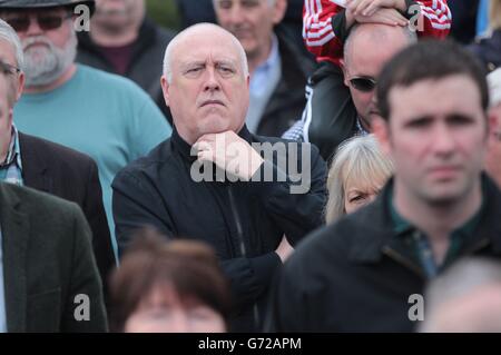 Sinn Fein-Unterhändler Danny Morrison schließt sich den Sinn Fein-Unterstützern an, die an der Enthüllung von Gerry Adams in der Falls Road, Belfast, Wie der stellvertretende erste Minister Martin McGuinness seine Überzeugung bekräftigt hat, dass die Verhaftung von Adams politisch motiviert sei und Mitgliedern des Polizeidienstes von Nordirland vorgeworfen wird, gegen den Friedensprozess zu sein. Stockfoto