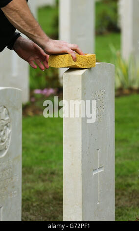 Myles Hunt Gardener Caretaker 1. Klasse auf dem Bayeux-Kriegsfriedhof in Bayeux, Frankreich, reinigt den letzten von rund 4000 Grabsteinen, die vor dem bevorstehenden 70. Jahrestag der Landungen des D-Day in der Normandie ersetzt wurden. Stockfoto