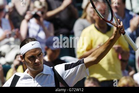 Titelverteidiger Roger Federer aus der Schweiz hebt seinen Schläger nach seinem Sieg über Sebastien Grosjean aus Frankreich im Halbfinale des Herren-Singles-Turniers bei den Lawn Tennis Championships in Wimbledon, London. Federer gewann das Spiel, das vom Vortag in geraden Sätzen 6:2/6:3/7:6 verschoben wurde. KEIN HANDY. Stockfoto