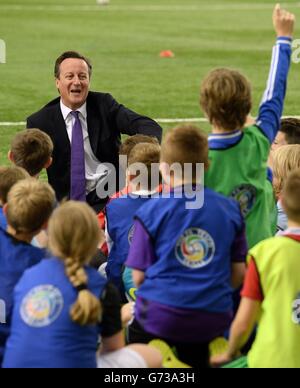 Premierminister David Cameron trifft Schulkinder bei einem Besuch im St. Georges Park , Englands Fußballtrainingszentrale, in Burton-upon-Trent. Stockfoto