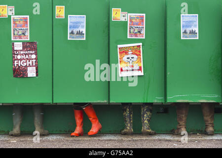 Festivalbesucher nutzen die neu installierten Long-Drop-Toiletten im Regen beim Glastonbury Festival auf der Worthy Farm in Somerset. Stockfoto