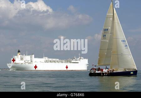 Das United States Naval Hospital Ship Comfort segelt aus der Solent Off Cowes, Isle of Wight an Yachten vorbei, die am dritten Tag der Cowes Week Segelregatta gegeneinander antreten. Der Rennsport wurde außer vier Klassen aufgrund von Windmangel eingestellt. *... die meisten der 890 Boote und 8,000 Segler wurden abgewellt. Stockfoto