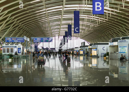 SHANGHAI, CHINA - Mai 2016: Flughafen Pudong Interieur und Passagiere in den Abflug-terminal, Shanghai, China. Stockfoto