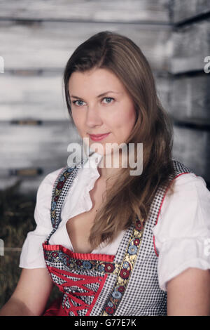 Schöne Frau im deutschen Tracht auf Heu Stockfoto