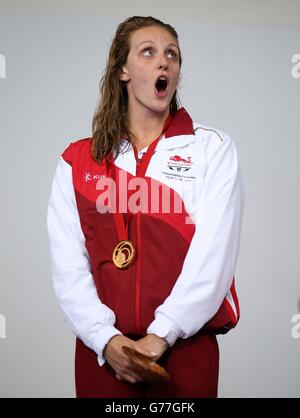 Die Engländerin Francesca Halsall singt die Nationalhymne mit ihrer Goldmedaille, nachdem sie bei den Commonwealth Games 2014 in Glasgow die 50 m Freistil der Frauen im Tollcross Swimming Center gewonnen hat. Stockfoto