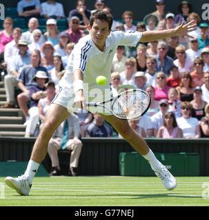 NUR ZUR REDAKTIONELLEN VERWENDUNG, KEINE HANDYNUTZUNG : Britische Tennis-Hoffnung Tim Henman im Kampf gegen Michael Llodra aus Frankreich auf dem Centre Court bei den All England Lawn Tennis Championships in Wimbledon. Stockfoto