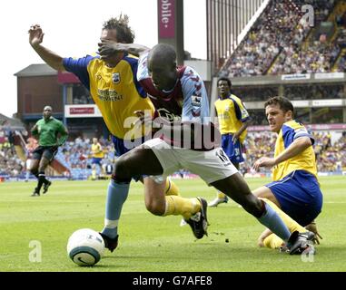 Carlton Cole von Aston Villa überspringt das Tackle vom Southampton-Paar Claus Lundervam (links) und Jason Dodd (rechts) während ihres Barclays Premiership-Spiels in Villa Park, Birmingham, am Samstag, 14. August 2004. Stockfoto