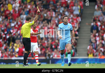 Schiedsrichter Mark Clattenburg (links) zeigt Manchester die gelbe Karte City's Frank Lampard (rechts) Stockfoto