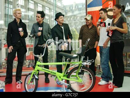 (Von links nach rechts) Mike Dirnt, Billie Joe Armstrong und Tre Cool von der Punkrock-Gruppe Green Day mit den Moderatoren Dave Berry und Emma Griffiths während ihres Gastauftritts auf MTV's TRL - Total Request Live - Show, in den neuen Studios im Leicester Square im Zentrum von London. Die Gruppe hat mit 'American Idiot' die britische Albumchart an die Spitze gesetzt. Stockfoto