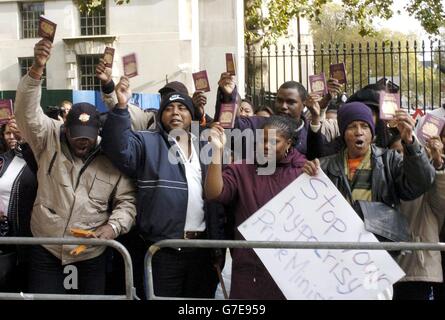 Exil-Bewohner der Insel Diego Garcia im Indischen Ozean demonstrieren gegenüber der Downing Street im Zentrum Londons. Bis zu 80 obdachlose Diego Garcian Exilanten versammelten sich in Downing Street, um Großbritannien zu bitten, sie zu beherbergen oder nach Hause zurückzubringen. Sie winkten mit ihren britischen Pässen in die Luft und skandierten: "Tony Blair ist ein Dieb. Gib uns unsere Inseln zurück.' Stockfoto