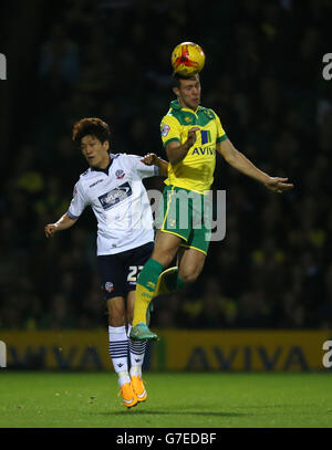 Fußball - Sky Bet Championship - Norwich City / Bolton Wanderers - Carrow Road. Steven Whittaker (rechts) von Norwich City kämpft mit Lee Chung-Yong von Bolton Wanderers (links) um den Ballbesitz in der Luft Stockfoto