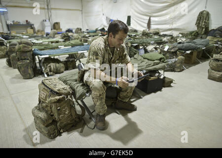 Staff Sergent Craig Worsley, 34, aus Swansea, von der 1. Garde der Königin Dragoon, sitzt in einer provisorischen Zeltunterkunft in Camp Bastion, während die Truppen sich darauf vorbereiten, aus dem Lager in der Provinz Helmand, Afghanistan, zurückzuziehen und nach Großbritannien zurückzukehren. Stockfoto