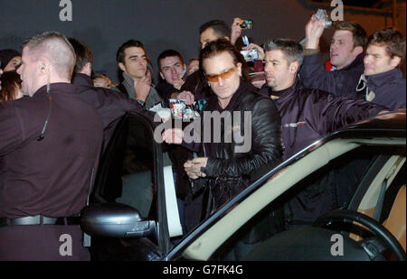 Sänger Bono von der irischen Rockband U2, signiert Autogramme für Fans vor den Studios der Band in Hanover Quay, Dublin, Irland, bevor er Songs von ihrem neuen Album "How To Diffuse an Atomic Bomb" live auf der BBC Zane Lowe Show aufführt. Stockfoto