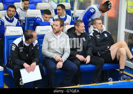 Von links nach rechts sitzen der Birmingham City Assistant Manager Kevin Summer Field, Manager Gary Rowett, Torwarttrainer Kevin Poole und der erste Teamtrainer Mark Sale vor dem Spiel in St. Andrews in den ausgegraben. Stockfoto