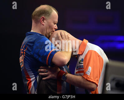 Darts - 2014 William Hill World Darts Championship - Tag Neun - Alexandra Palace. Raymond van Barneveld (links) besiegt Jamie Cavern während der William Hill World Darts Championship im Alexandra Palace, London. Stockfoto