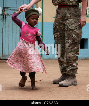 Ein Kind trägt einen Tam O'Shanter, während Soldaten von 2 Schotten das Nanyuki Kinderheim besuchen, um den Waisenkindern Geschenke zu spenden, während Soldaten des 2. Bataillons, des Royal Regiment of Scotland, an der Übung Askari Storm am Stadtrand von Nanyuki, Kenia, teilnehmen. Stockfoto