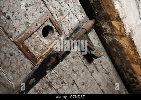 Alte Tür mit Guckloch und Vorhängeschloss in Kilmainham Gaol in Dublin, Irland Stockfoto