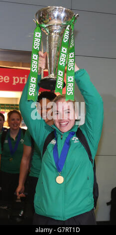 Irlands Rugby-Kapitän Niamh Briggs hält die Six Nations-Trophäe hoch, während sie mit Fans feiert, als das Team am Flughafen Dublin ankommt, nachdem es die Six Nations-Trophäe bei einem 73-3-Sieg über Schottland in Glasgow gewonnen hat. Stockfoto