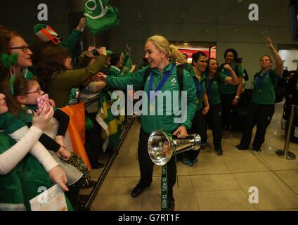 Irlands Rugby-Kapitän Niamh Briggs hält die Six Nations-Trophäe, während sie mit Fans feiert, als das Team am Flughafen Dublin ankommt, nachdem es die Six Nations-Trophäe bei einem 73-3-Sieg über Schottland in Glasgow gewonnen hat. Stockfoto