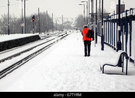 Ein Mitglied der Öffentlichkeit kämpft gegen das Wetter am Bahnhof Sittingbourne in Kent. Da Schnee und Schnee weite Teile des Südostens überzogen, störten die Bahnverbindungen nach London stark. Stockfoto