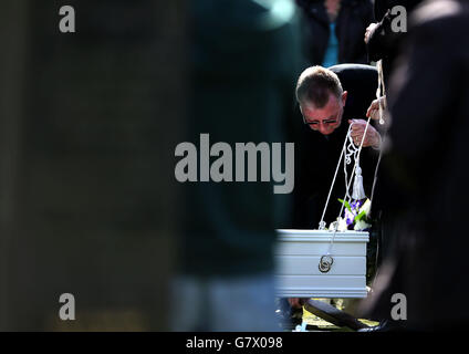 Der Sarg eines nicht identifizierten Jungen wird auf dem Seafield Cemetery, Edinburgh, fast zwei Jahre nachdem er tot auf einem Pfad aufgefunden wurde, in sein Grab gesenkt. Stockfoto